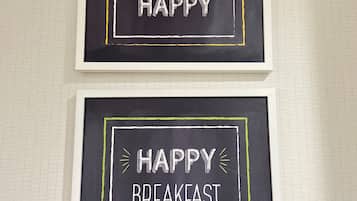 Two framed signs with motivational messages on a textured wall.