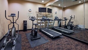 A fitness center with treadmills, stationary bikes, and a water dispenser. - Best Western Longview (Longview)