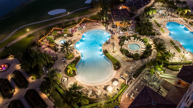 An aerial view of a resort with multiple swimming pools, landscaped gardens, and outdoor seating areas. - Rosen Shingle Creek (Orlando)
