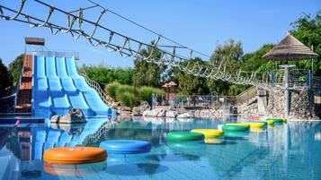 Enjoy a refreshing swim in the pool surrounded by lush greenery and a rope bridge.