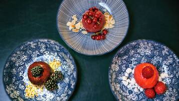 Three plates with food, each with a different pattern and garnishes.