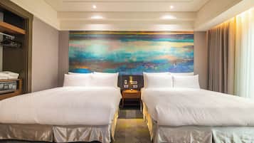 Habitación de hotel con dos camas, un cuadro abstracto grande en la pared, una mesita de noche con lámpara y vista a la ciudad por la ventana.