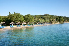 On the beach, sun-loungers, beach umbrellas, beach bar