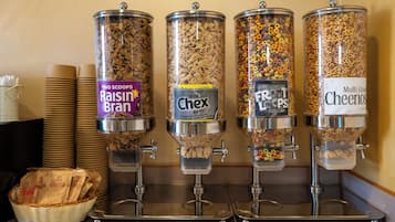 Four cereal dispensers with labels for Raisin Bran, Rice Chex, Fruity Loops, and Cheerios.