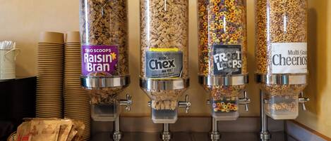 Four cereal dispensers with labels for Raisin Bran, Rice Chex, Fruity Loops, and Cheerios.