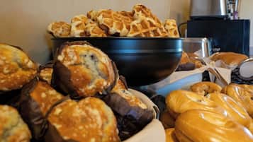 A variety of baked goods including waffles, muffins, and pastries in a bowl.