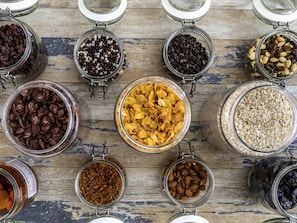 A variety of food items in glass jars on a wooden surface. - ibis Styles Crolles Grenoble A41 (Crolles)