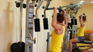 A gym with exercise equipment, including a squat rack and weight benches.