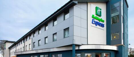 A Holiday Inn Express building with a modern design, featuring a flat roof and large windows.