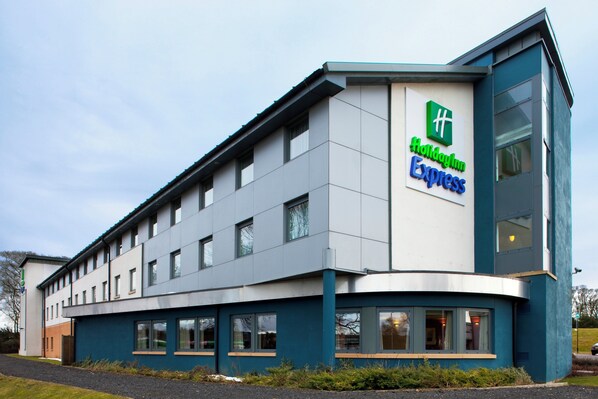 A Holiday Inn Express building with a modern design, featuring a flat roof and large windows.
