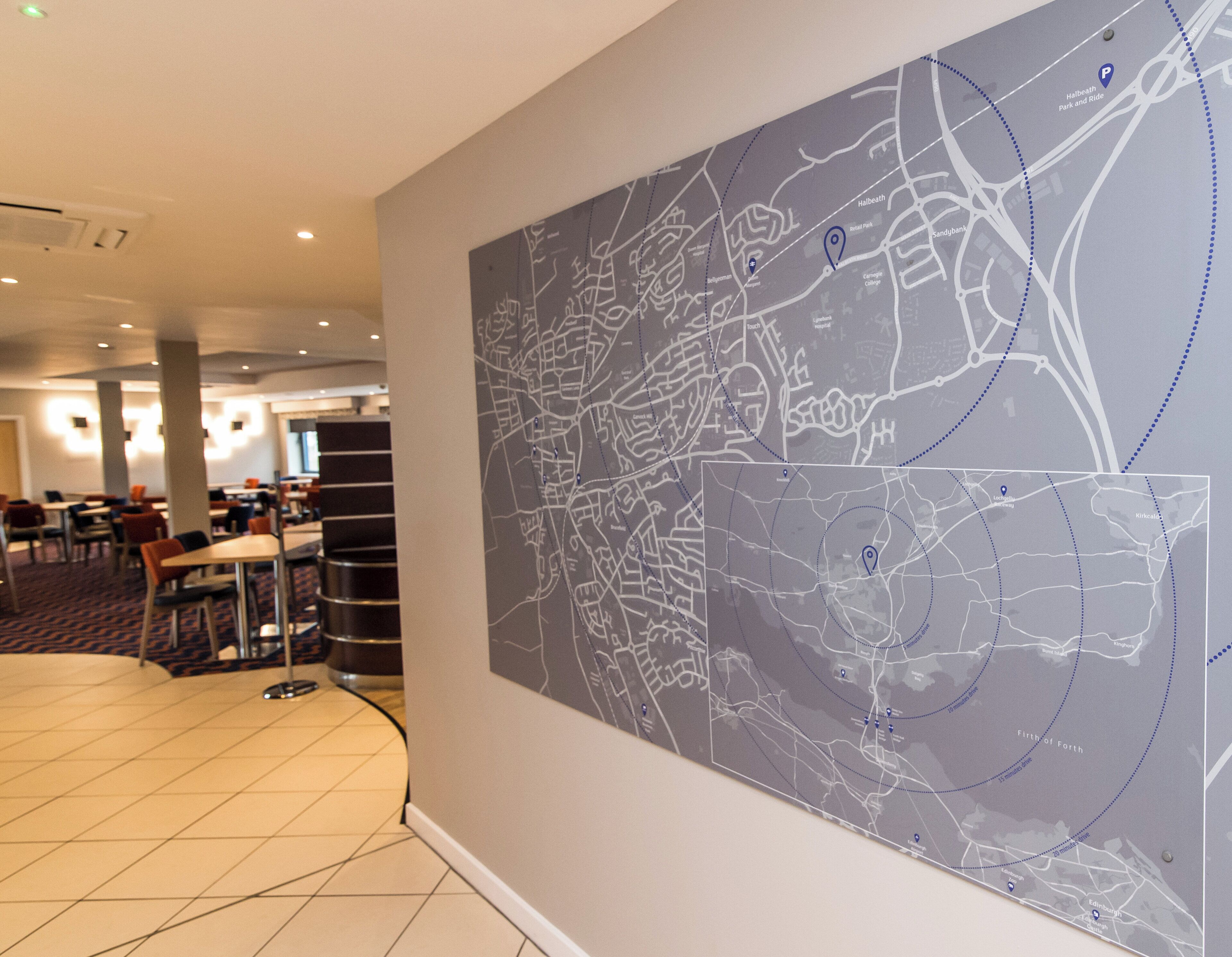 A map on a wall with a dining area in the background.