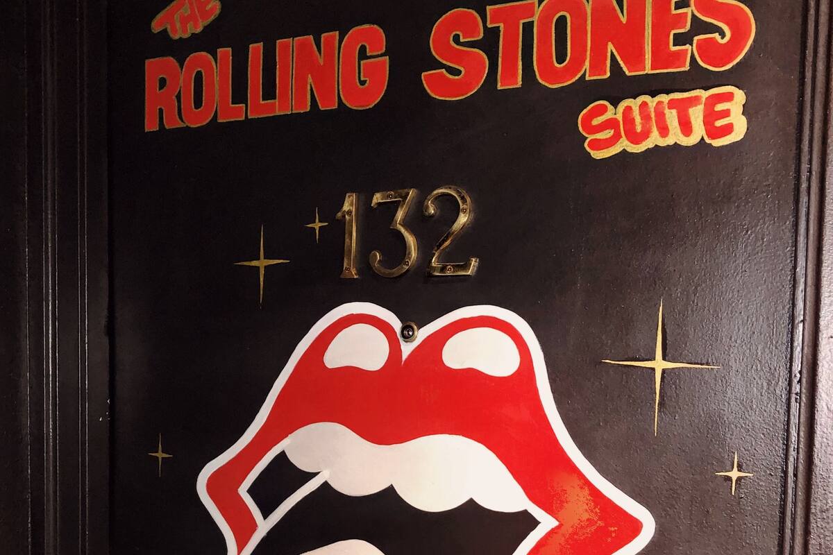 A door with the Rolling Stones Suite sign, a number 132, and a stylized Rolling Stones logo.
