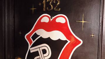 A door with the Rolling Stones Suite sign, a number 132, and a stylized Rolling Stones logo.