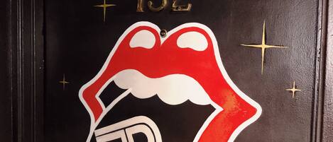 A door with the Rolling Stones Suite sign, a number 132, and a stylized Rolling Stones logo.