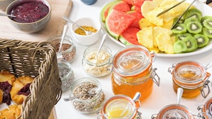 A breakfast buffet with various food items and condiments.