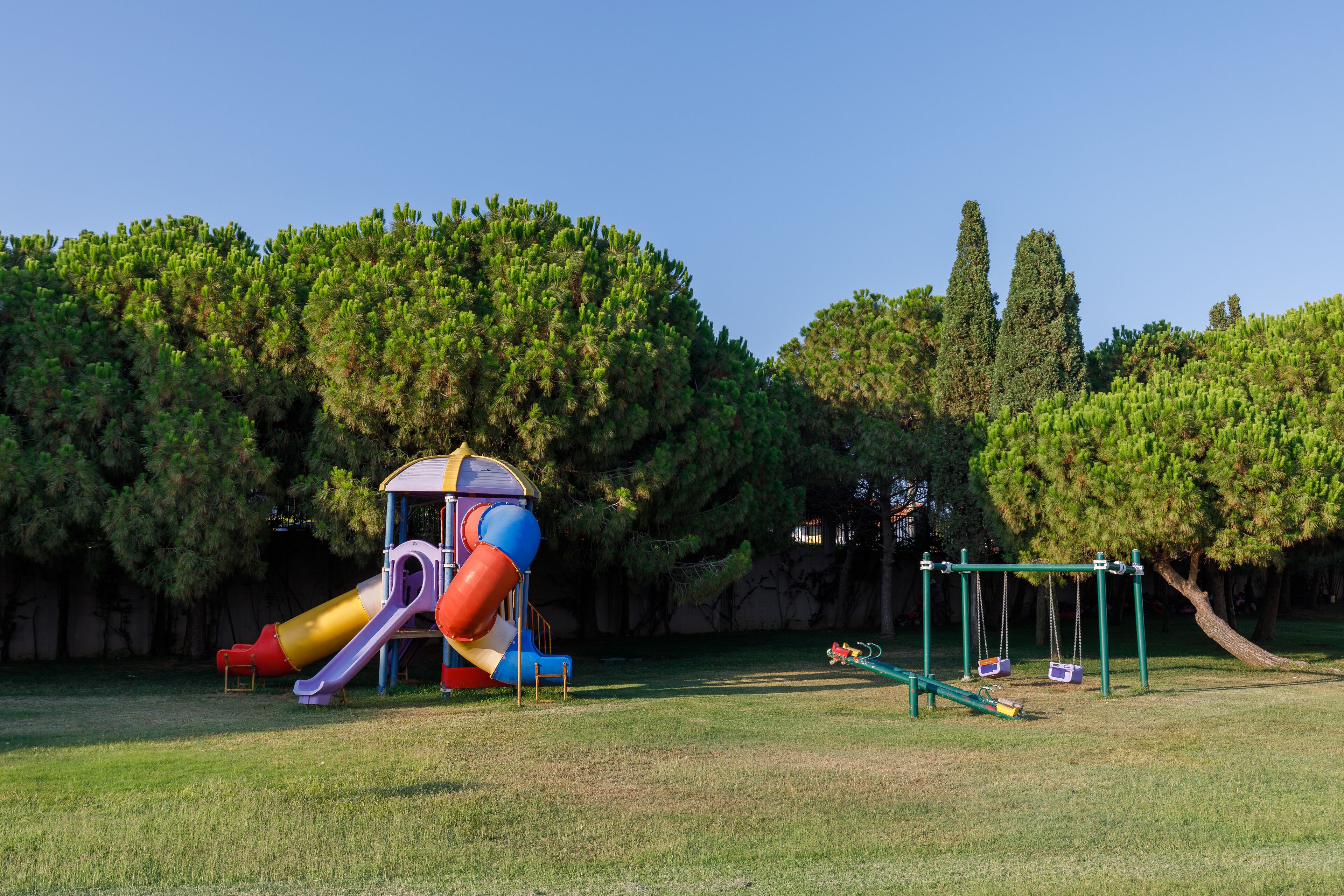 A playground with a slide, swings, and a climbing structure.