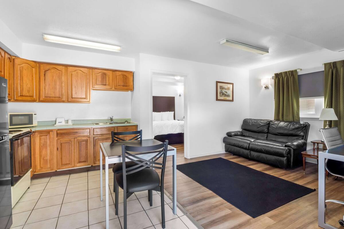 A compact living space with a kitchenette, dining area, and a seating area.