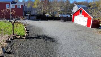 A gravel driveway leading to a red barn labeled "The Dine Dary."