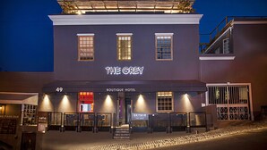 A building with the sign "THE GREY BOUTIQUE HOTEL" and a "SKYBAR" sign below it.