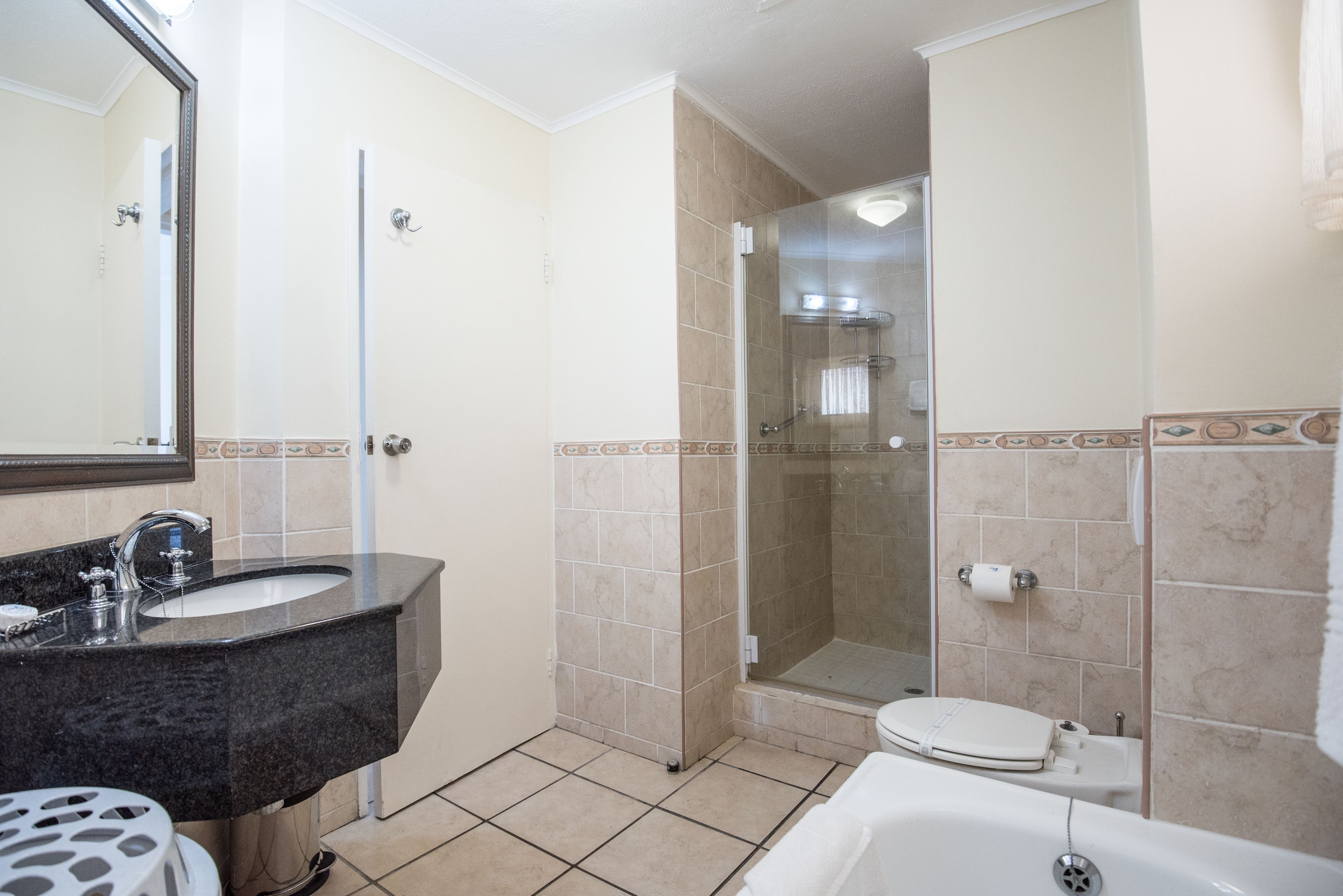A bathroom with a sink, toilet, and shower.