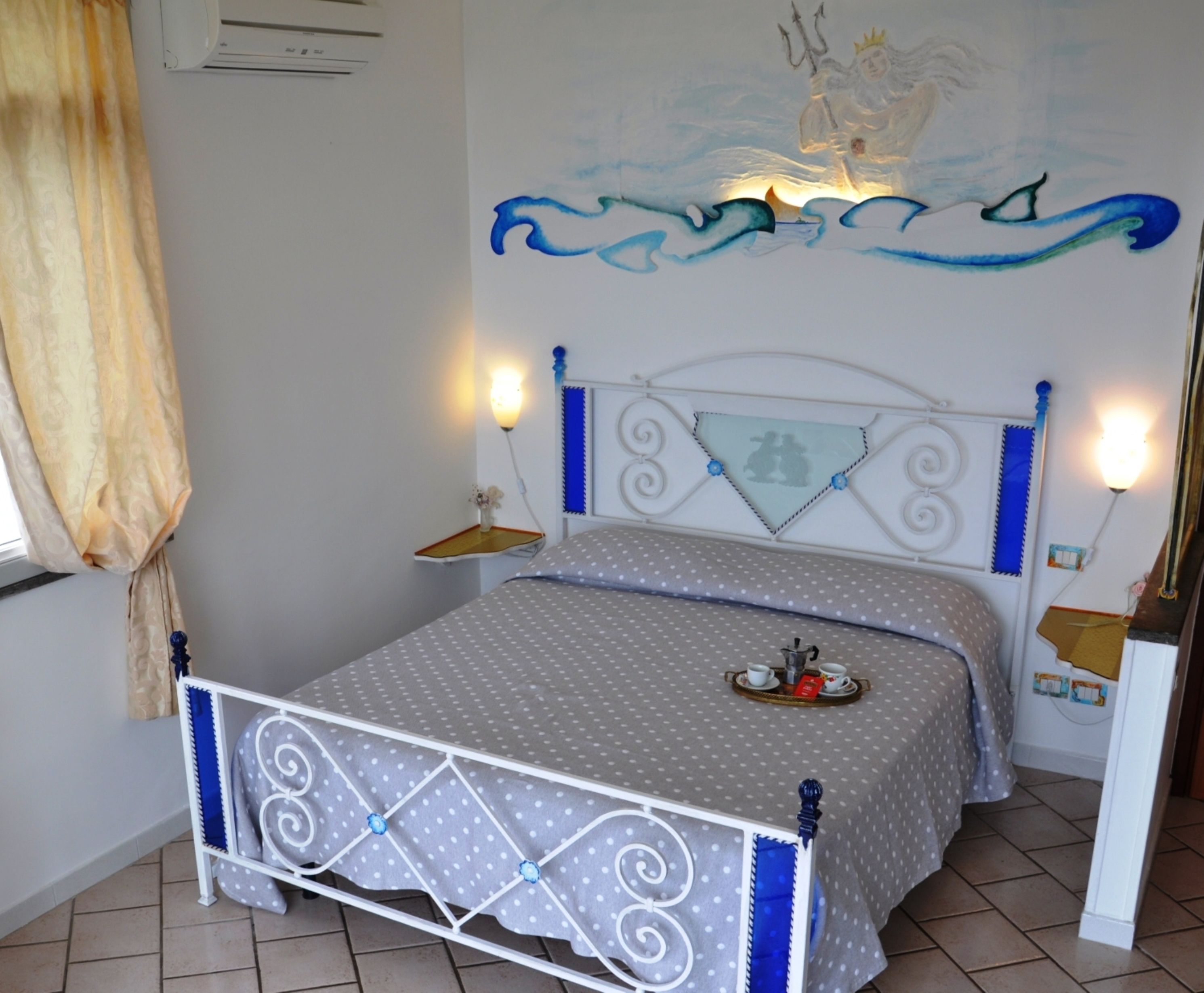 A bedroom with a bed, a nightstand, a wall painting, and a window with curtains.