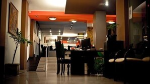 A hotel lobby with a staircase, seating area, and a reception desk. - Hotel del Fundador (Córdoba)