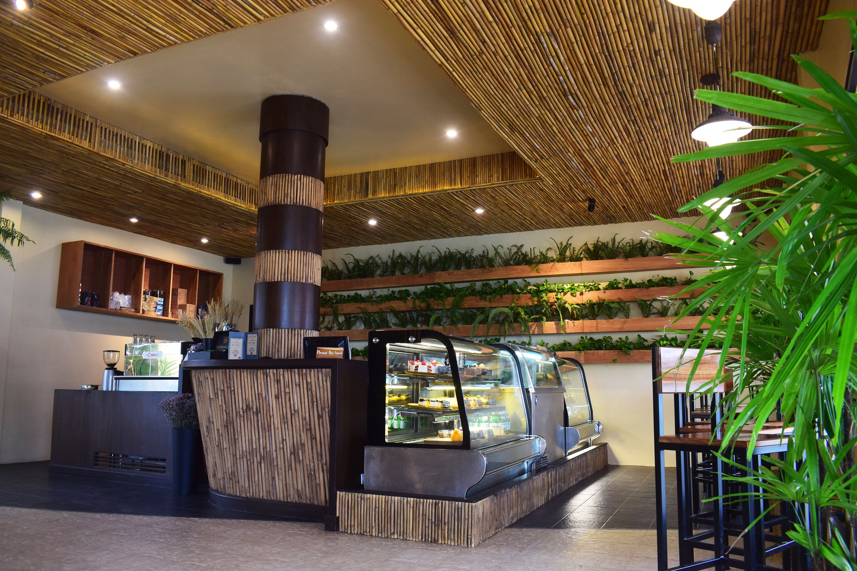 A modern interior with a central counter, a display case, and seating area.