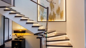 A modern staircase with a glass railing and a wooden finish, leading to an upper level. - Wainstones Hotel (Middlesbrough)