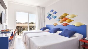 A hotel room with two beds, a desk, and a balcony with a view.