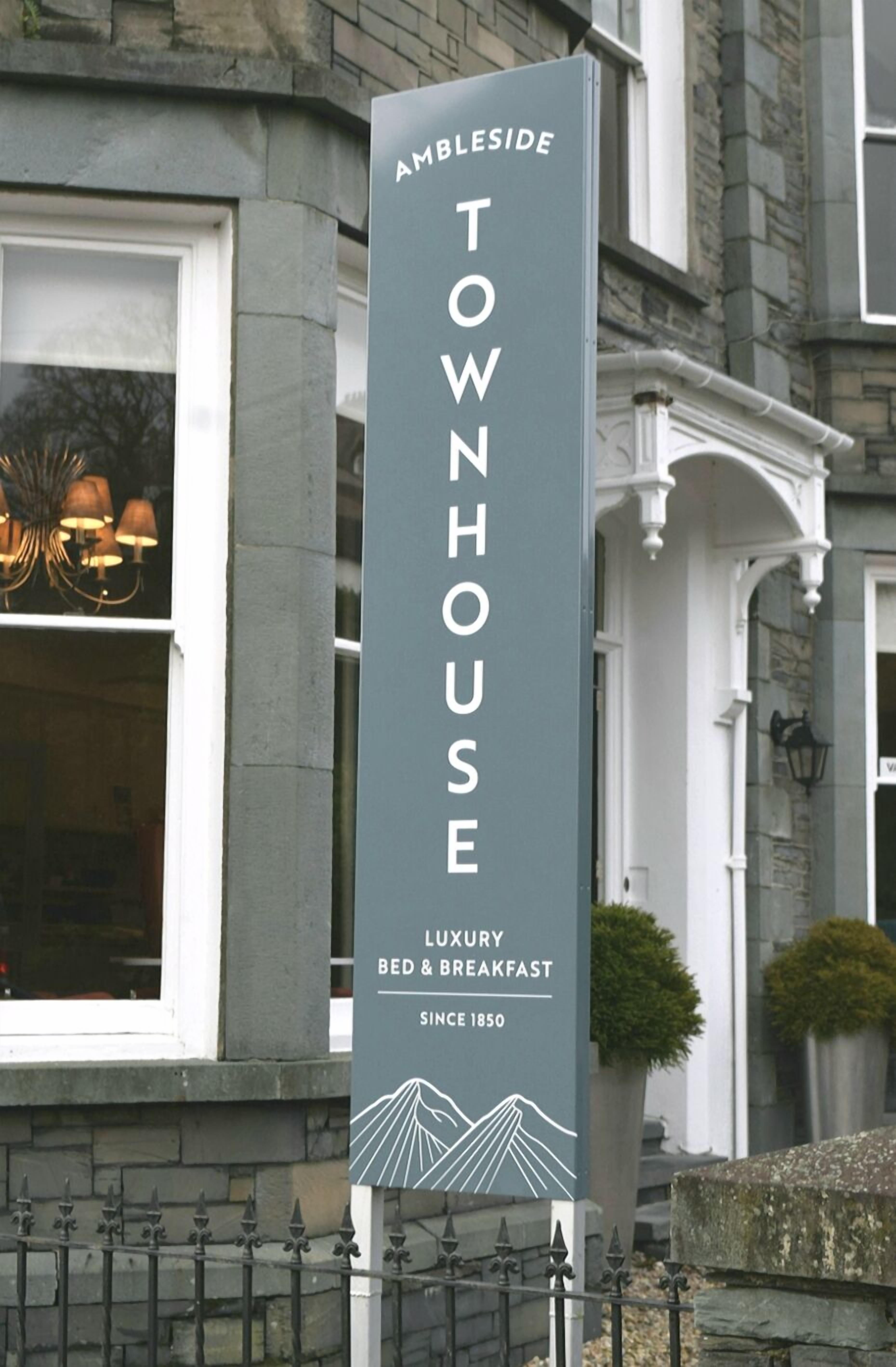 A sign for Ambleside Townhouse, indicating it offers luxury bed and breakfast services since 1850.