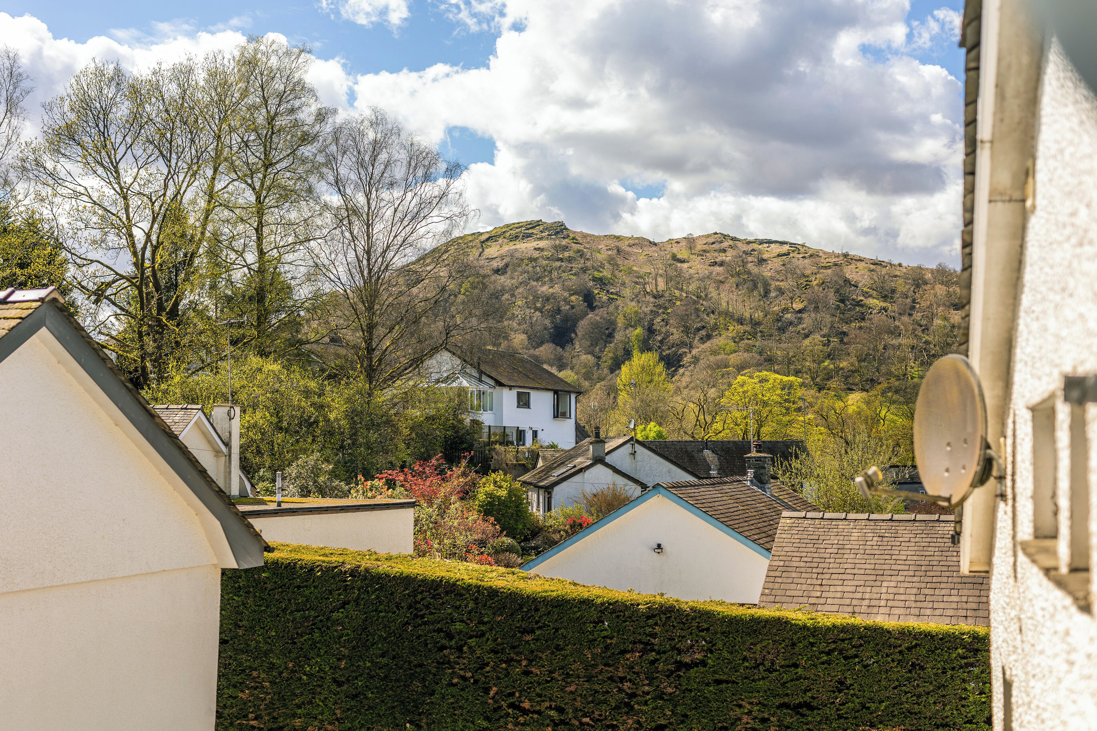 Un barrio residencial con casas, una colina y una antena parabólica.