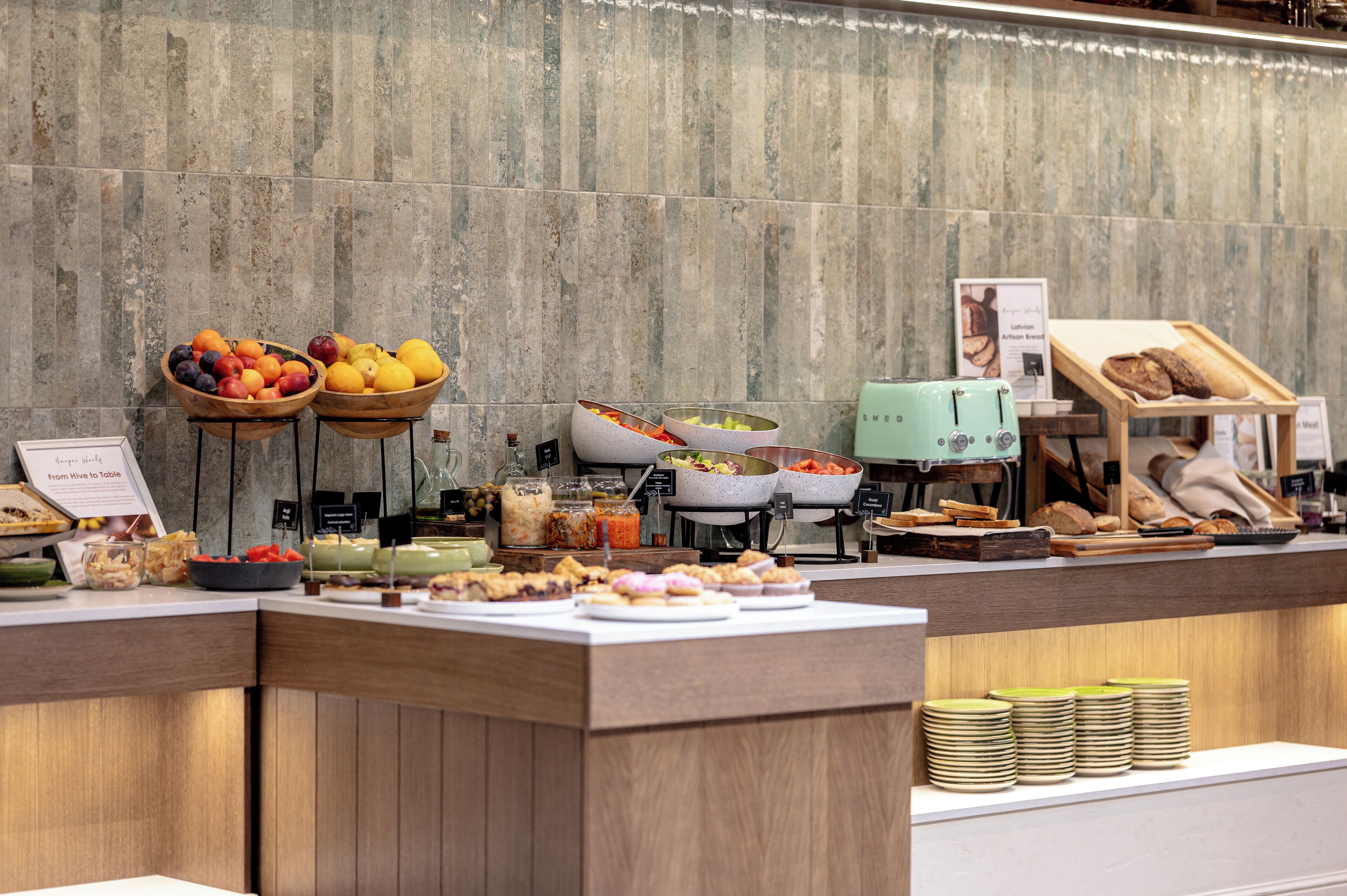 A buffet with various food items and a bread display.