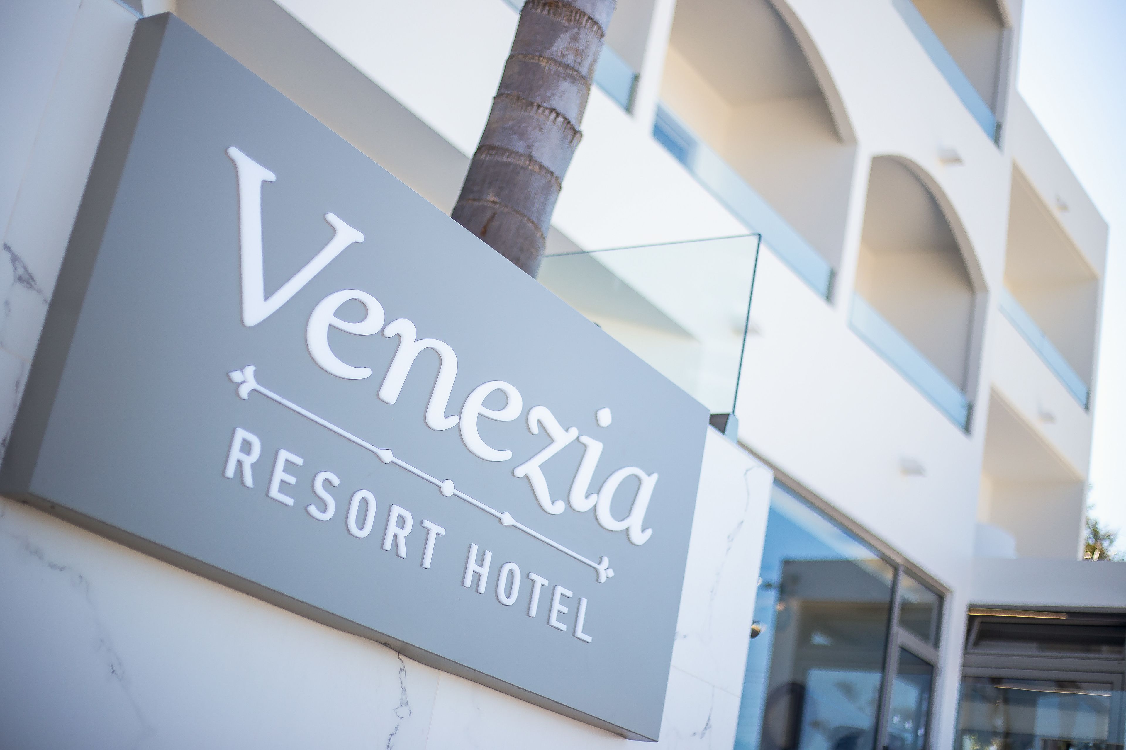 A sign for Venezia Resort Hotel.