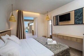 A hotel room with a bed, a TV, a bathroom vanity, and a view of a pool and outdoor area. - Venezia Resort Hotel & Spa - All inclusive (Rhodes)