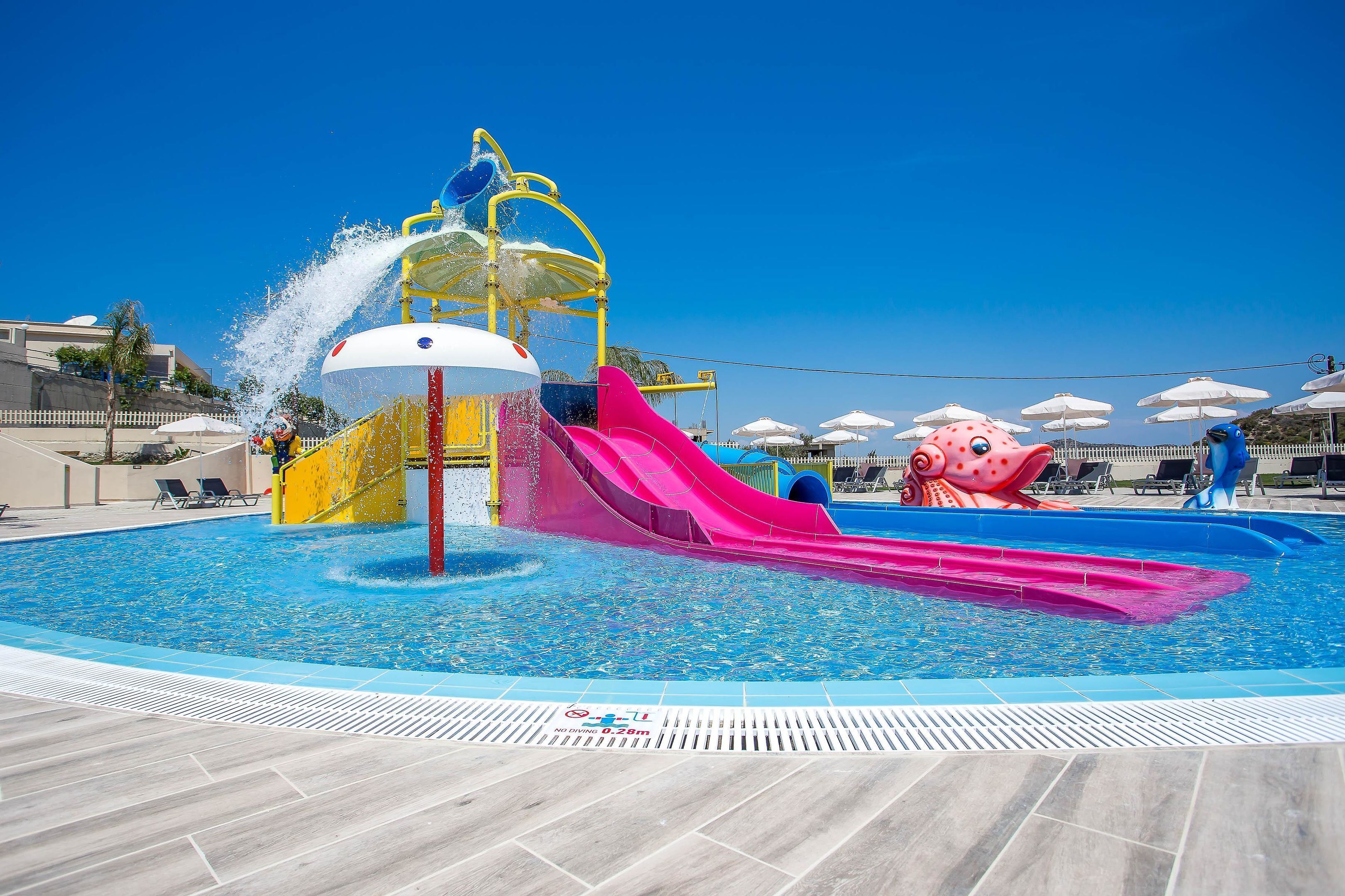 A water park with a large pool, slides, and a water play area.