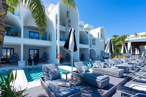 A modern hotel with a pool area, lounge chairs, and a dining area. - Venezia Resort Hotel & Spa - All inclusive (Rhodes)