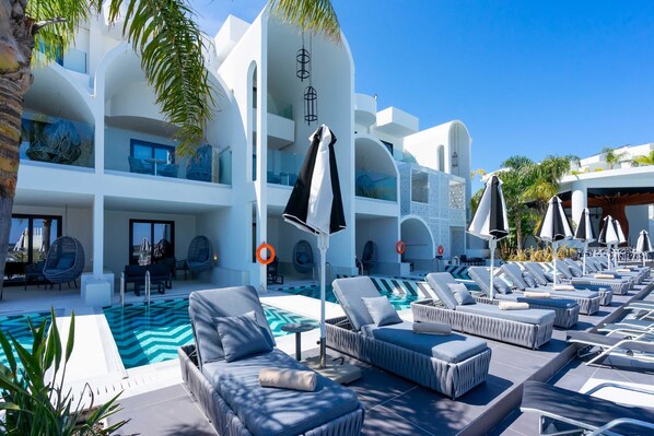 A modern hotel with a pool area, lounge chairs, and a dining area. - Venezia Resort Hotel & Spa - All inclusive (Rhodes)