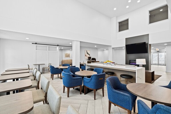 A modern interior with a dining area, kitchen, and bar/lounge space. - Staybridge Suites Calgary Airport by IHG (Calgary)