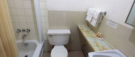 A small bathroom with a toilet, sink, and bathtub.