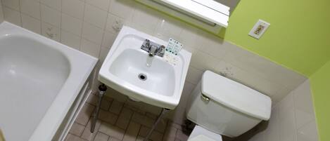 A bathroom with a bathtub, sink, and toilet.