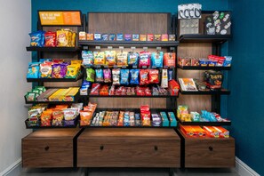 A snack display with various brands and types of chips, crackers, and other snacks. - Hampton Inn South Plainfield-Piscataway (South Plainfield)
