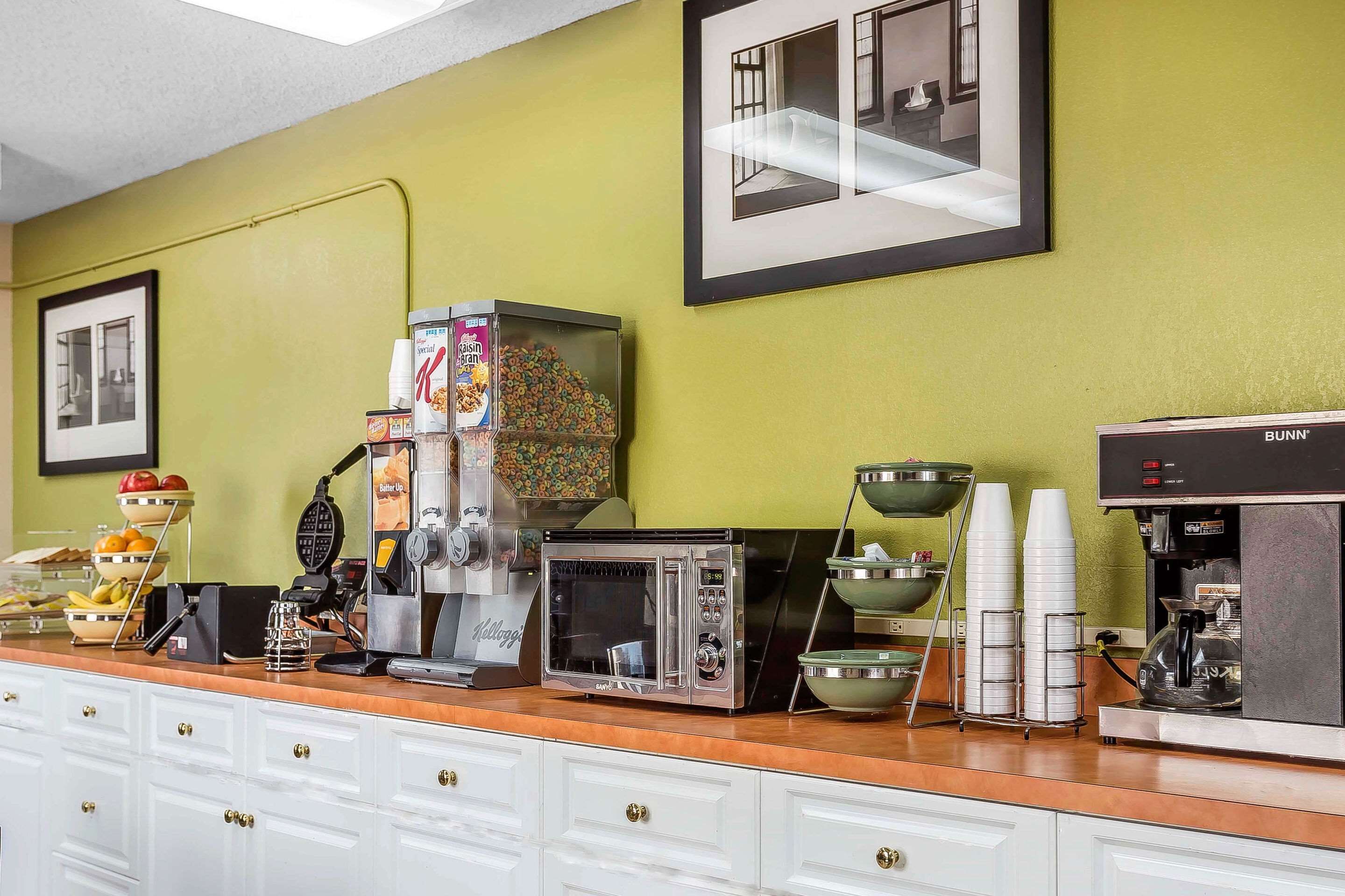 A kitchenette with a coffee machine, toaster, and various food containers.