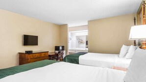 A hotel room with two beds, a wooden dresser, a flat-screen TV, and a window with a view of the outside. - Rodeway Inn Augusta South (Augusta)