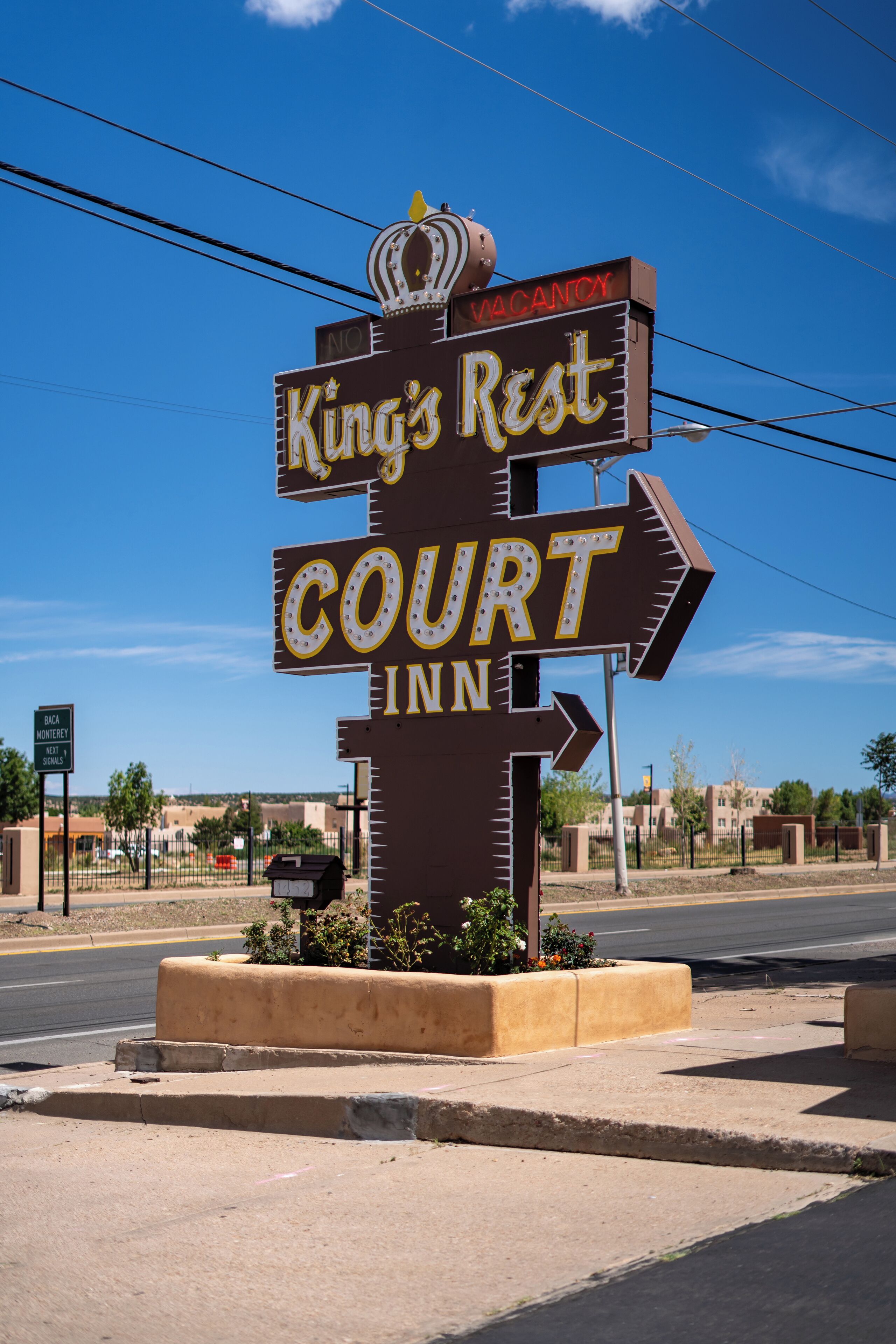 A sign for King's Rest Court Inn with directional arrows and a crown symbol.