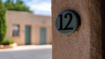 A house number '12' on a textured wall.