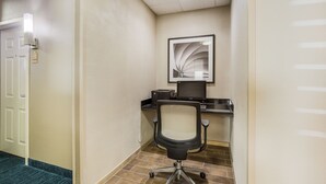 A hotel room with a desk, chair, and a framed picture on the wall. - Candlewood Suites Virginia Beach Town Center by IHG (Virginia Beach)