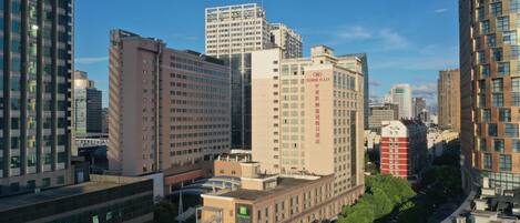 A high-rise hotel with multiple floors, a prominent sign, and a mix of modern and traditional architecture.