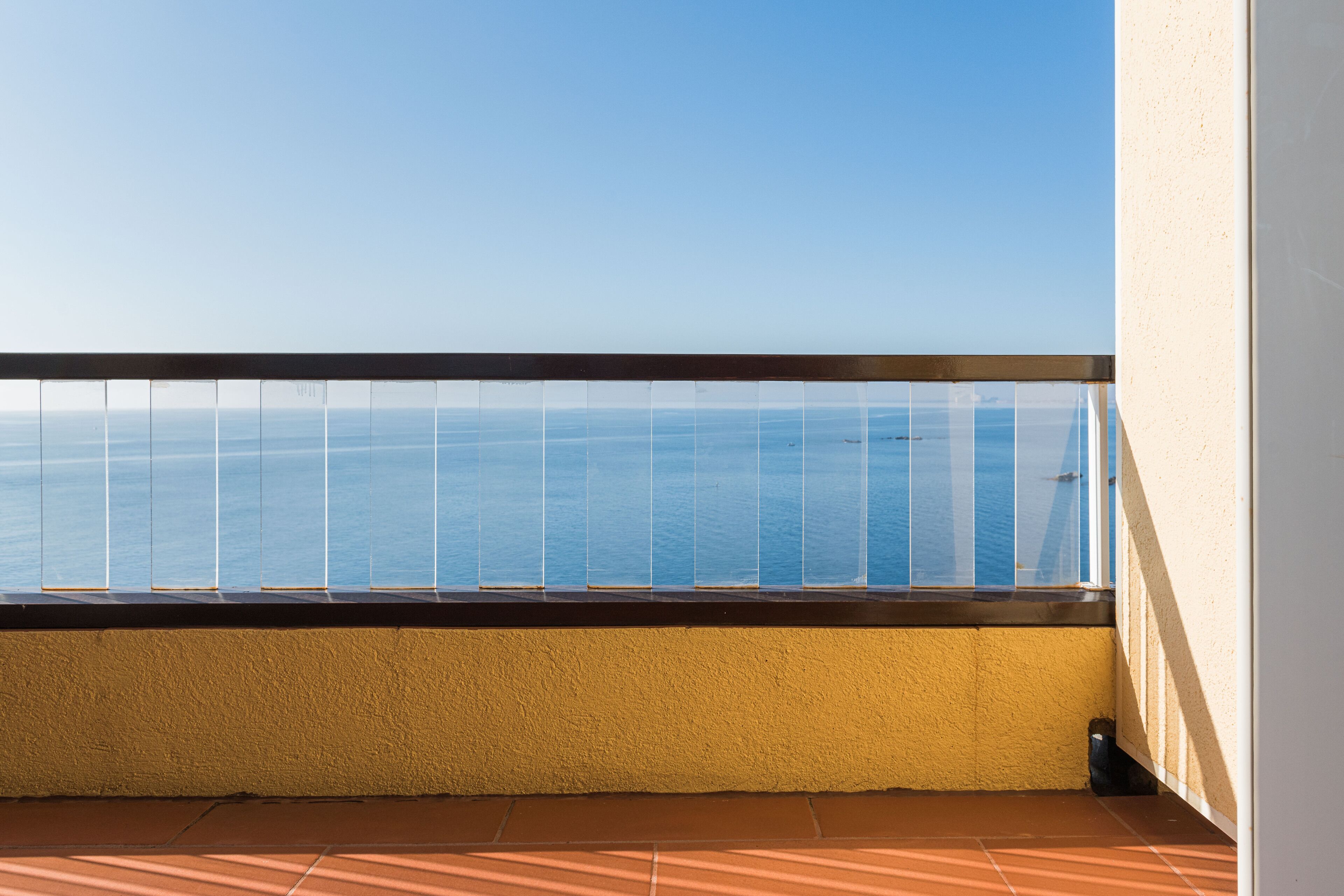 A balcony with a view of the sea.
