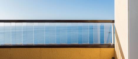 A balcony with a view of the sea.