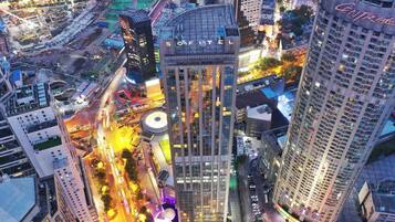 Experience the vibrant city from our high-rise hotel, offering stunning views of the surrounding urban landscape.